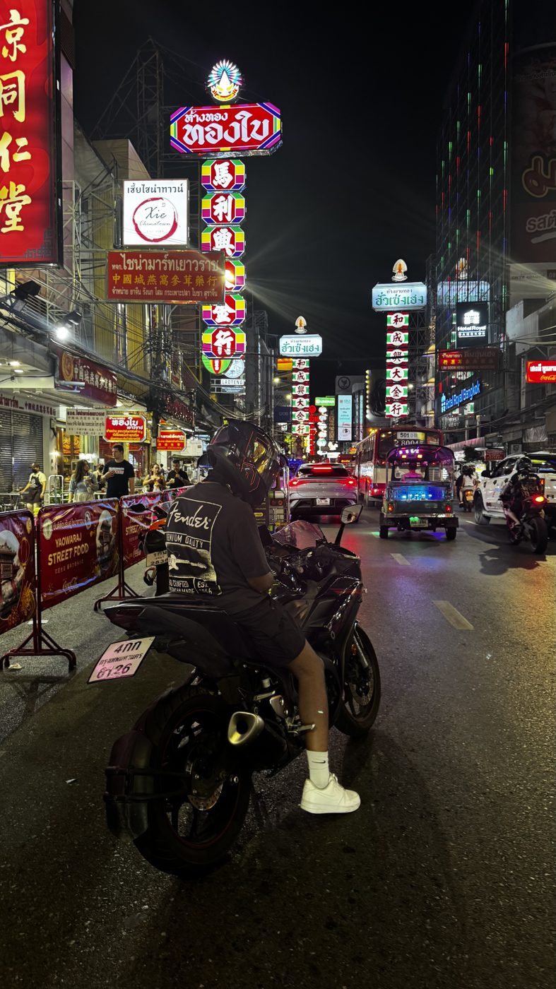 Ken on his motorcycle at night on Yaowarat Road, Bangkok